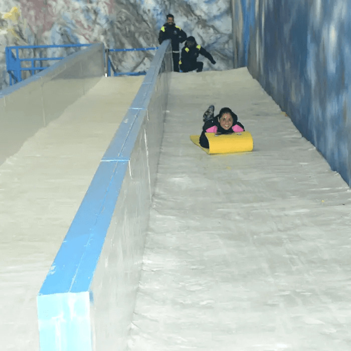 Girl sliding in Snow Park