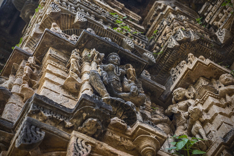 detailed sculpture of an ancient deity adorning the walls of a historic temple